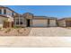Charming home with a two-car garage and nicely landscaped front yard, enhancing curb appeal and functionality at 18219 W Hess St, Goodyear, AZ 85338