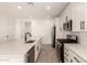 Contemporary kitchen featuring stainless appliances, sleek white cabinetry, and a functional kitchen island at 18219 W Hess St, Goodyear, AZ 85338