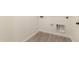 Functional laundry room featuring neutral tones, utility hook ups and tiled floor at 18219 W Hess St, Goodyear, AZ 85338