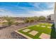 Landscaped backyard with artificial turf and desert landscaping at 18897 N 264Th Ln, Buckeye, AZ 85396