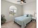 Comfortable bedroom with carpeted floor, large window, and ceiling fan at 18897 N 264Th Ln, Buckeye, AZ 85396