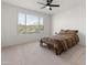 Bright bedroom with large window and ceiling fan at 18897 N 264Th Ln, Buckeye, AZ 85396