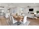 Bright dining area with wood table and white chairs, near kitchen at 18897 N 264Th Ln, Buckeye, AZ 85396