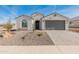 Single story home with grey garage door and landscaping at 18897 N 264Th Ln, Buckeye, AZ 85396