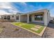 Rear view of house showcasing a covered patio and artificial turf at 18897 N 264Th Ln, Buckeye, AZ 85396