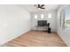 Home office with wood-look floors, large window, and ceiling fan at 18897 N 264Th Ln, Buckeye, AZ 85396