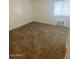 Large carpeted bedroom with a window and air conditioning unit at 1945 W Sweetwater Ave # 2013, Phoenix, AZ 85029