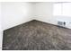 Spacious carpeted bedroom with window and closet at 1945 W Sweetwater Ave # 2013, Phoenix, AZ 85029