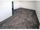 Bright bedroom featuring carpet floors and an exterior door at 1945 W Sweetwater Ave # 2013, Phoenix, AZ 85029