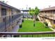 Community courtyard with lush green grass and trees at 1945 W Sweetwater Ave # 2013, Phoenix, AZ 85029