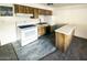 Galley kitchen with wood cabinets and white appliances at 1945 W Sweetwater Ave # 2013, Phoenix, AZ 85029