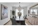 Elegant dining room with a large table and statement light fixture at 20007 N 96Th Way, Scottsdale, AZ 85255