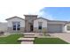 Beautiful single-story home featuring stone accents, manicured lawn and a spacious two car garage at 20233 W San Miguel Ave, Litchfield Park, AZ 85340