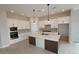 Modern kitchen featuring white cabinets, stainless steel appliances, and a large center island at 20233 W San Miguel Ave, Litchfield Park, AZ 85340
