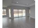 Bright and airy living room featuring tile floors and large sliding glass doors leading to the patio at 20233 W San Miguel Ave, Litchfield Park, AZ 85340