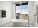 Bathroom with freestanding tub and mountain views at 21312 N 113Th Pl, Scottsdale, AZ 85255