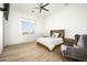 Bright bedroom with mountain views, hardwood floors, and a ceiling fan at 21312 N 113Th Pl, Scottsdale, AZ 85255