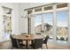 Bright dining room with large windows showcasing scenic mountain views at 21312 N 113Th Pl, Scottsdale, AZ 85255