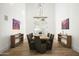 Spacious dining room featuring a long table, modern chandelier, and wood floors at 21312 N 113Th Pl, Scottsdale, AZ 85255