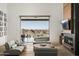 Bright living room featuring sliding glass doors to a patio with mountain views at 21312 N 113Th Pl, Scottsdale, AZ 85255