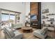 Open living area with a modern fireplace and light hardwood floors at 21312 N 113Th Pl, Scottsdale, AZ 85255