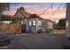 Cozy backyard with patio area, perfect for relaxing and entertaining under festive string lights at sunset at 2209 E Weldon Ave, Phoenix, AZ 85016