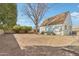 Backyard features dirt, a brown roof home, a large tree, bushes, and a brick trim at 2209 E Weldon Ave, Phoenix, AZ 85016