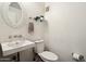 Charming powder room features white fixtures and ornate mirror at 2209 E Weldon Ave, Phoenix, AZ 85016