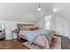 Attic bedroom with a bed, hardwood floors, a bedside table, neutral color palette, and a door to an ensuite bathroom at 2209 E Weldon Ave, Phoenix, AZ 85016