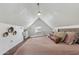 Attic bedroom features a bed, hardwood floors, a window, neutral color palette, and a sloped ceiling at 2209 E Weldon Ave, Phoenix, AZ 85016