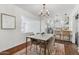 Bright dining area with modern table, stylish chairs, and open kitchen access at 2209 E Weldon Ave, Phoenix, AZ 85016