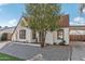 Charming white brick home with brown trim, mature tree, and brick-lined walkway to the entrance at 2209 E Weldon Ave, Phoenix, AZ 85016