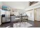 Modern kitchen featuring gray cabinets, stainless steel appliances, an island with stools, and a TV at 2209 E Weldon Ave, Phoenix, AZ 85016