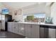 Well-lit kitchen featuring sleek gray cabinets, modern appliances, and a large window above the sink at 2209 E Weldon Ave, Phoenix, AZ 85016