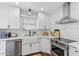 Modern white kitchen with stainless steel dishwasher, farmhouse sink, and subway tile backsplash at 2209 E Weldon Ave, Phoenix, AZ 85016