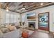 Comfortable living room featuring a fireplace, stylish decor, and a rustic wood ceiling at 2209 E Weldon Ave, Phoenix, AZ 85016