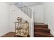 Hallway staircase with a bar cart, black iron railing, white risers, and hardwood treads leading to the upper level at 2209 E Weldon Ave, Phoenix, AZ 85016