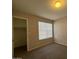 Well-lit bedroom featuring carpet and closet at 2255 W Rose Garden Ln, Phoenix, AZ 85027