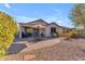 Home's backyard with patio and landscaping at 22992 W Lasso Ln, Buckeye, AZ 85326