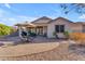 Home's backyard with patio and landscaping at 22992 W Lasso Ln, Buckeye, AZ 85326