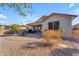 Home's backyard with patio, landscaping, and gravel at 22992 W Lasso Ln, Buckeye, AZ 85326