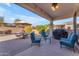 Backyard patio with seating, umbrella, and grill at 22992 W Lasso Ln, Buckeye, AZ 85326