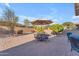 Backyard patio with table, chairs, and umbrella at 22992 W Lasso Ln, Buckeye, AZ 85326