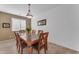 Bright dining room with wood table and chairs at 22992 W Lasso Ln, Buckeye, AZ 85326