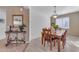 Dining room features wood table and chairs, and a chandelier at 22992 W Lasso Ln, Buckeye, AZ 85326