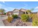 House exterior with landscaping and a rock pathway at 22992 W Lasso Ln, Buckeye, AZ 85326