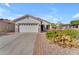 Single-story home with desert landscaping and a two-car garage at 22992 W Lasso Ln, Buckeye, AZ 85326