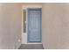 Light blue front door with a sidelight window at 22992 W Lasso Ln, Buckeye, AZ 85326