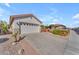 Two-car garage with driveway and desert landscaping at 22992 W Lasso Ln, Buckeye, AZ 85326