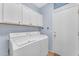 Laundry room with white cabinets and washer/dryer hookups at 22992 W Lasso Ln, Buckeye, AZ 85326